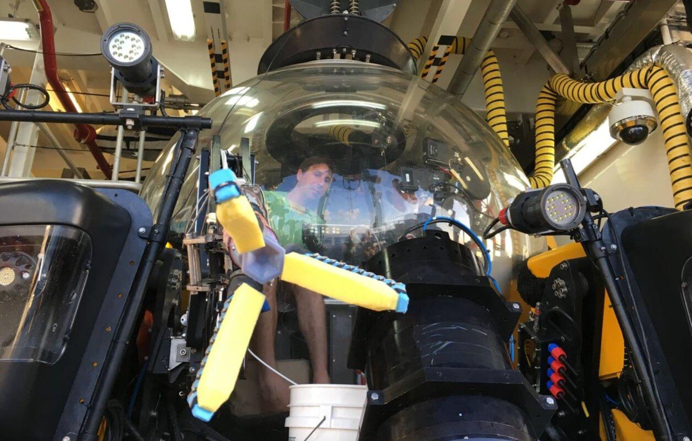 Brennan Phillips inside a robotic underwater exploration vehicle