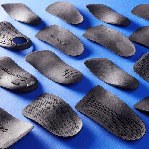 3D printed insoles on blue background