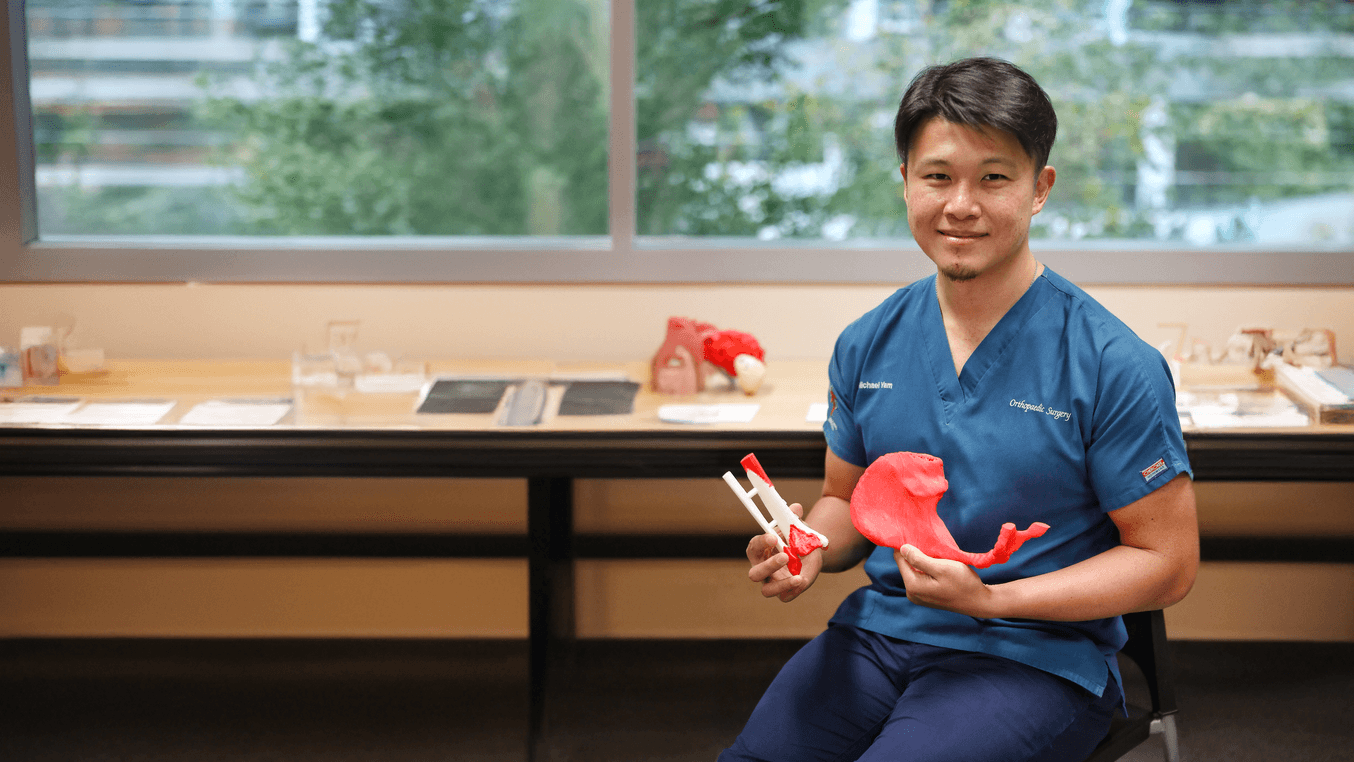 Dr. Yam holding 3D printed models