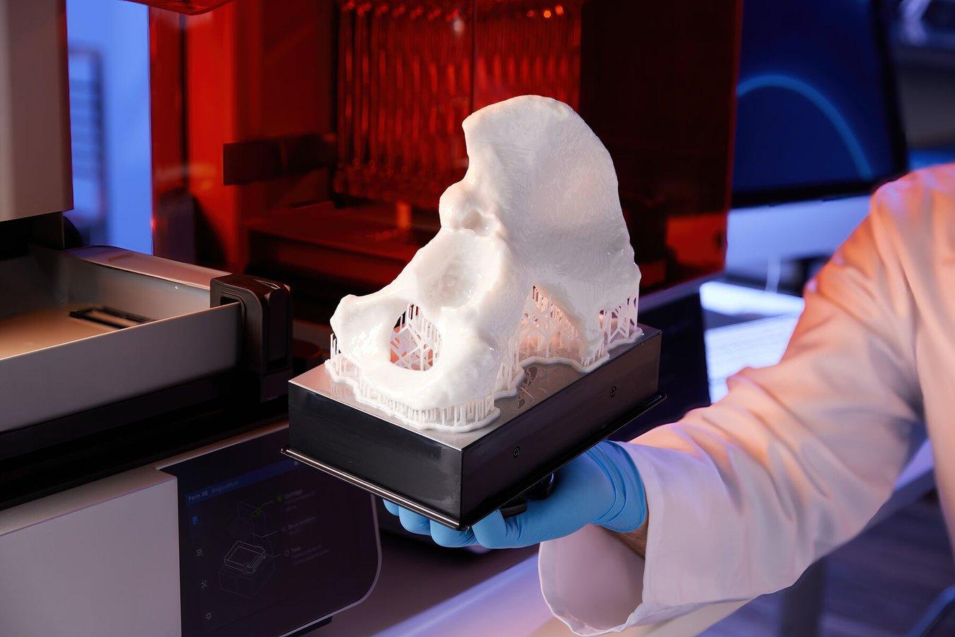 Modello anatomico bianco di un osso su una piattaforma di stampa