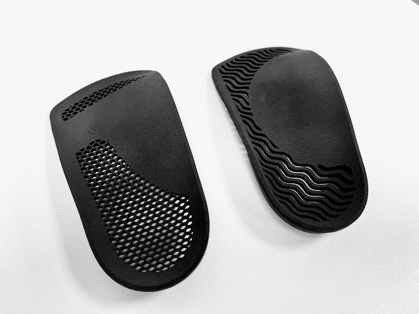Two black 3D printed insoles