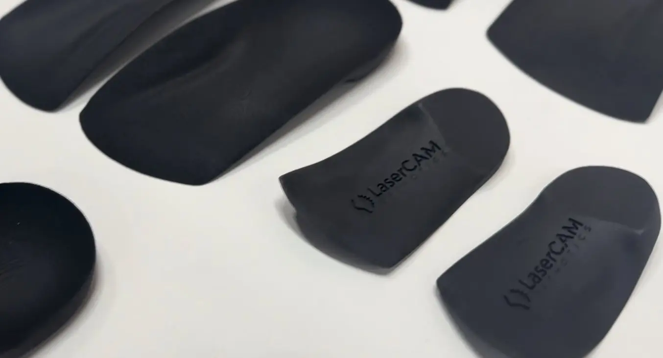 Various 3D printed insoles with LaserCAM logo