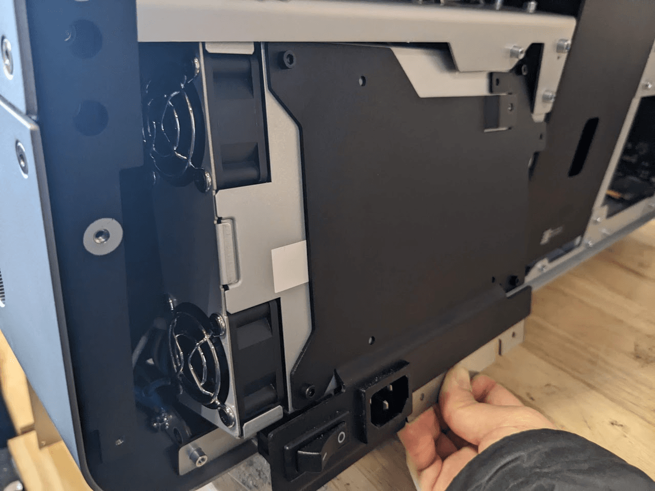Slide the top of the power supply assembly underneath the printer frame.