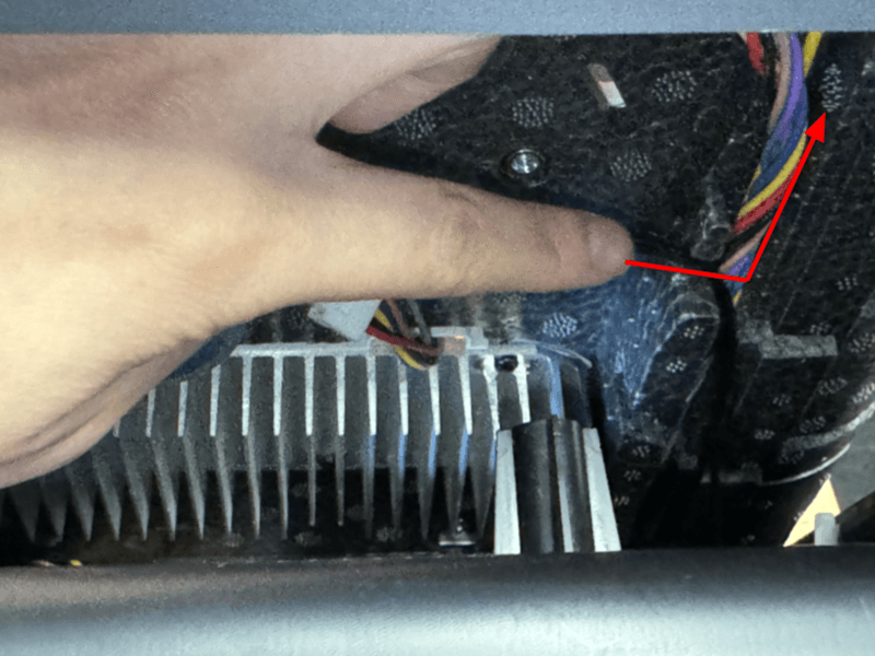 Press the motor cable through the grooved pathway alongside the multicolored LED module cable harness.