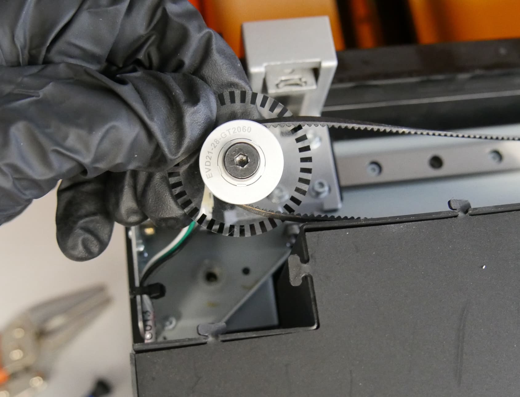 Step 3: Mount the mixer idler pulley and encoder wheel assembly