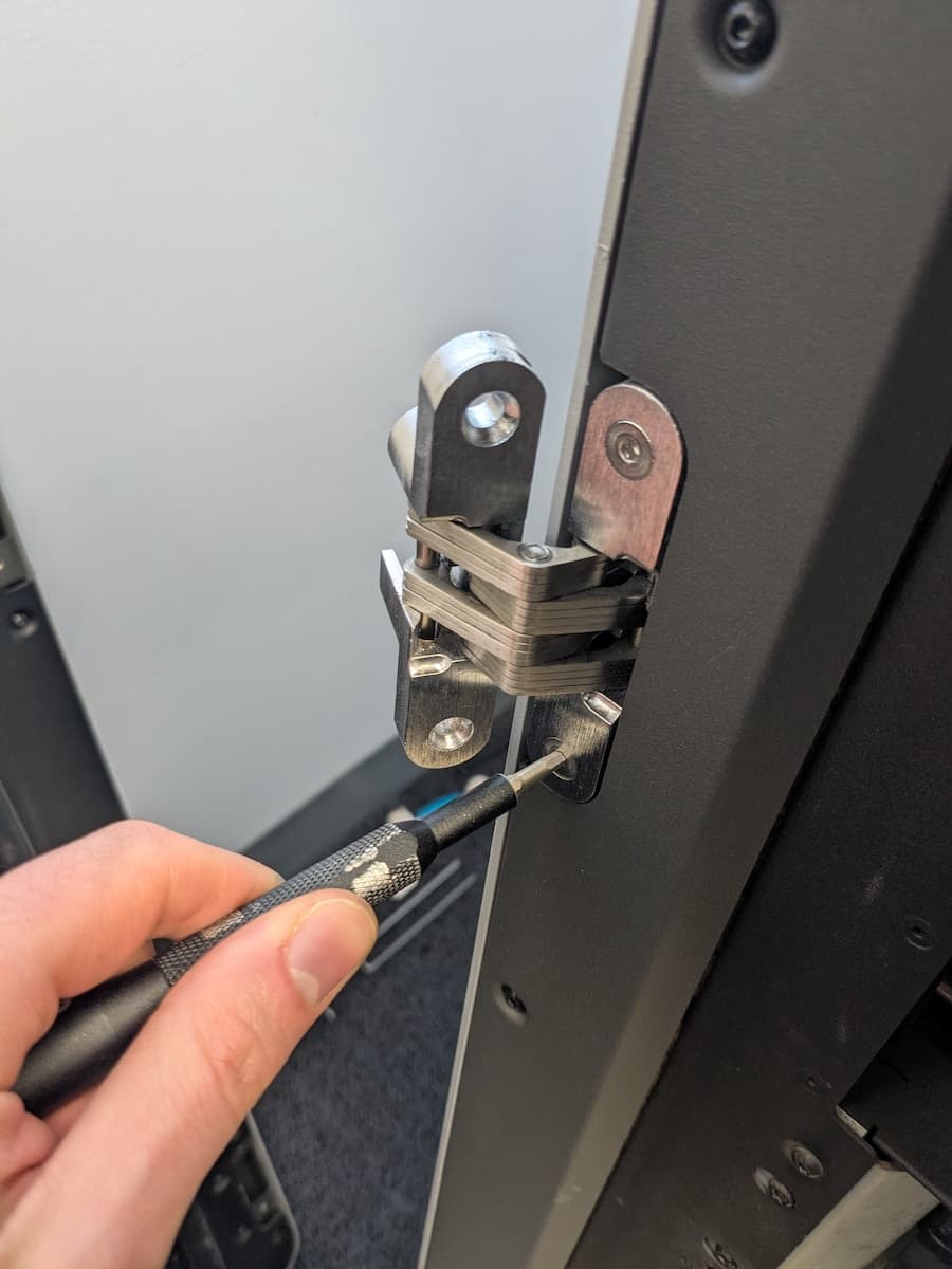 Step 3: Remove the hinge mounting screws from the printer