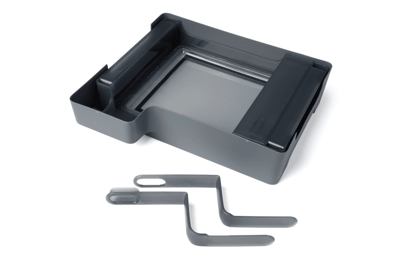 A photo of a resin tank inside the case and next to the tank tool.