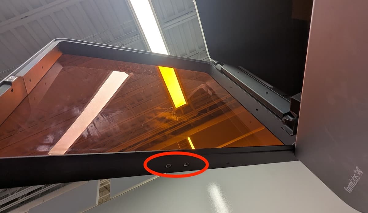 Form 4L generation: The printer has two round interlock magnets on the bottom edge of the door, each secured by a screw.