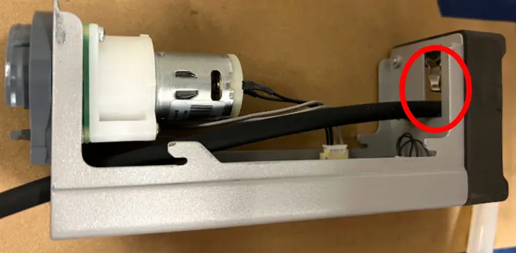 Route the pump tube through the resin pump