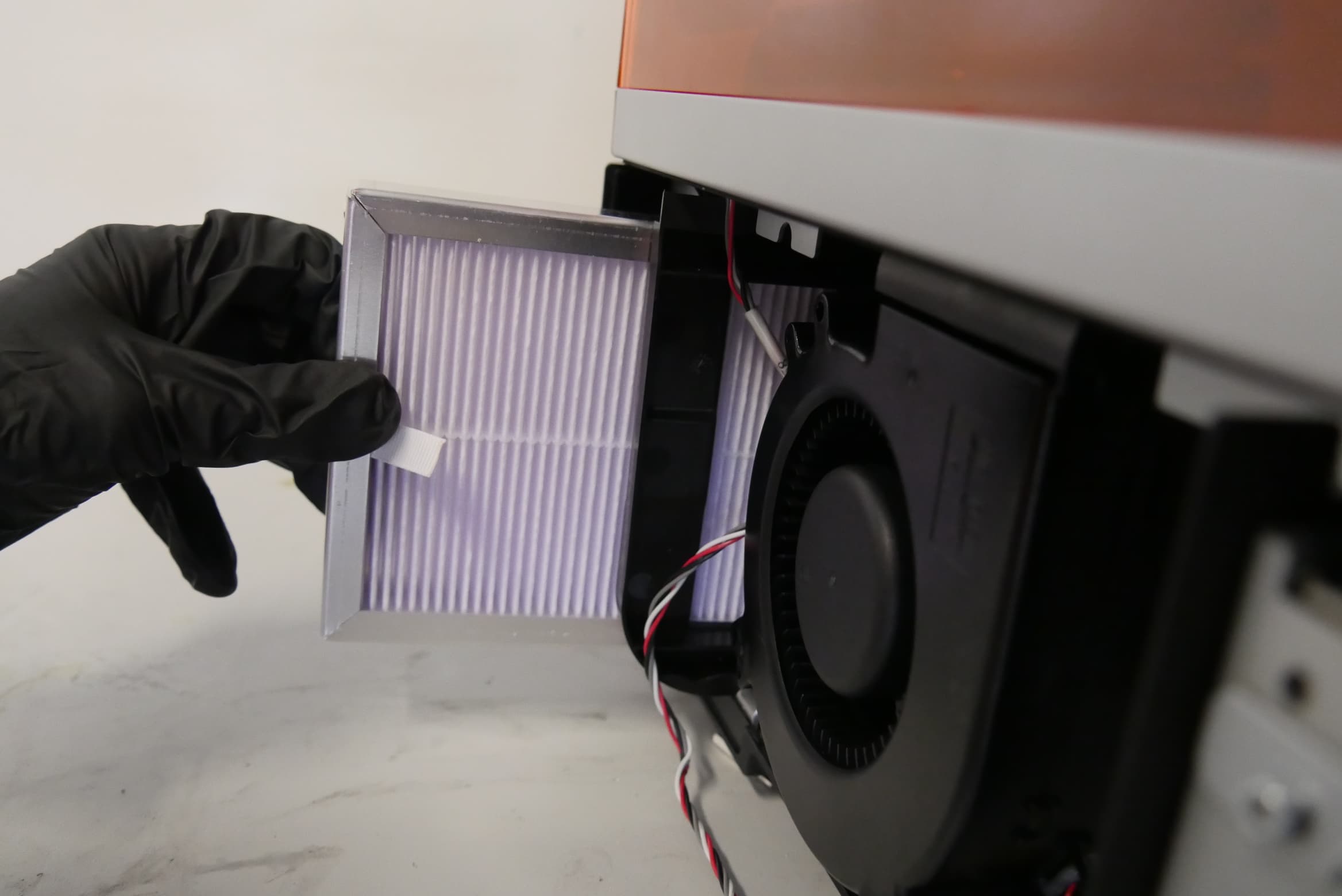 Inserting the replacement Form 4 LPU fan filter into its housing