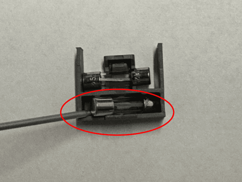 Using a flathead screw driver, gently pry the blown fuse from the fuse box.