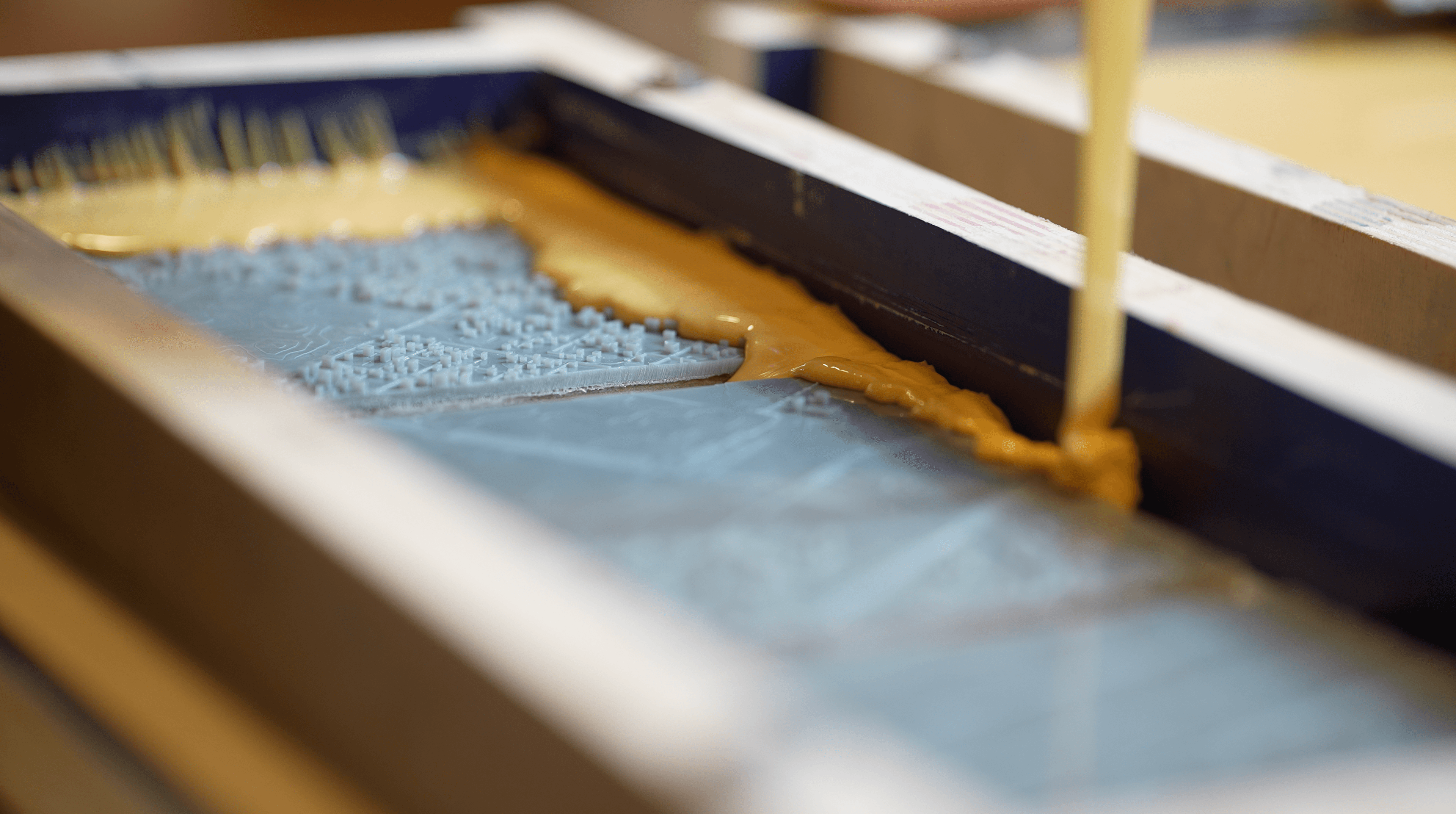 Pouring mold material on top of 3D prints.