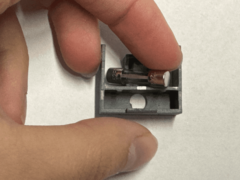 Using a finger, gently pry the replacement fuse from the fuse box.