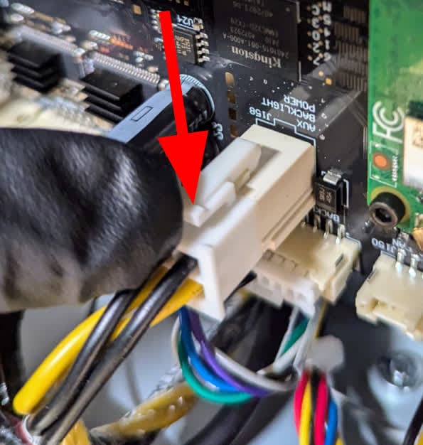 Disconnecting the power cable from the motherboard on a Form 4 generation printer