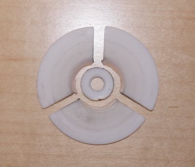 A broken washer is shown split into four pieces.