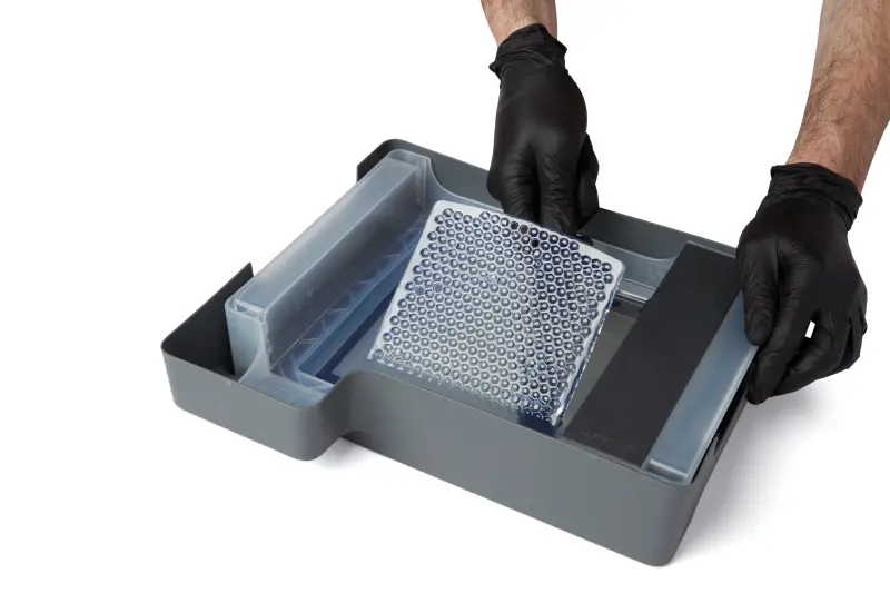 A photo showing the entire cleaning mesh being peeled up off the bottom of the tank.