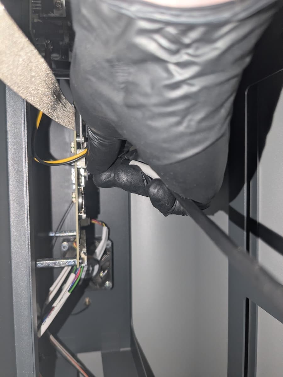Disconnecting the solvent monitor cable from the motherboard