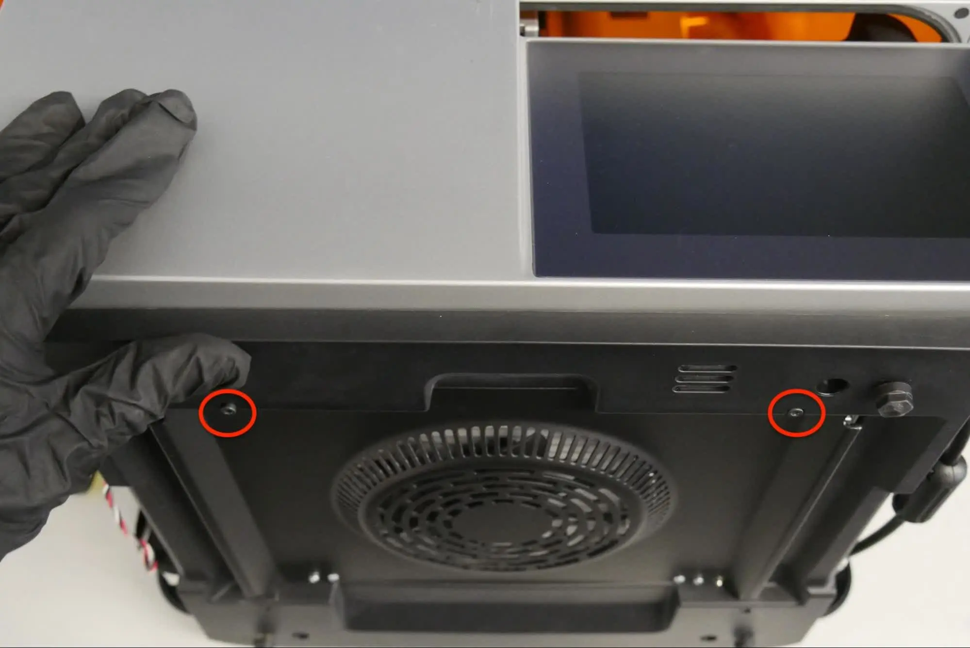 Step 7: Loosen the bottom panel retention screws