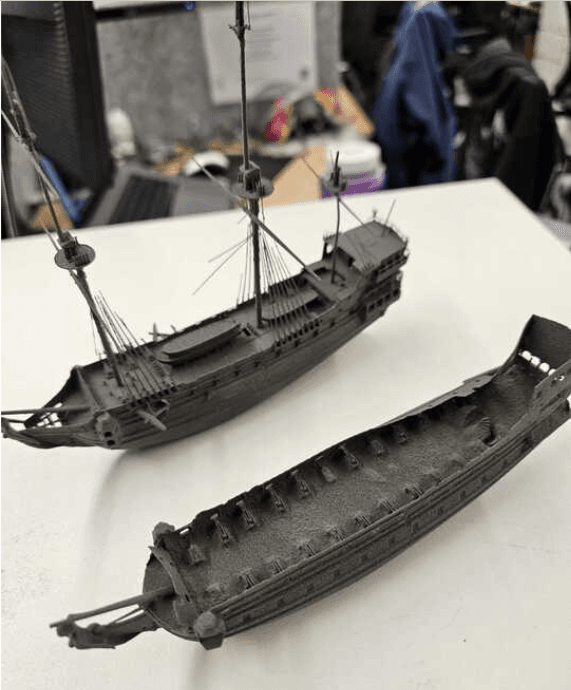 Two printed parts sitting side by side. One part is missing features.