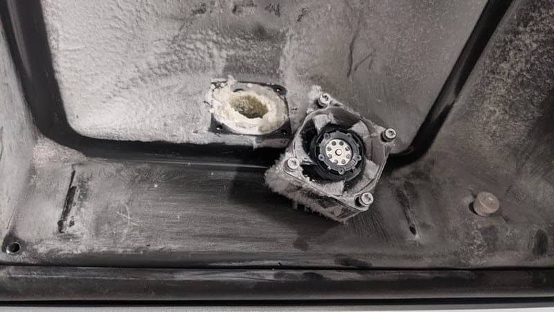 The exhaust filter and exhaust fan have been removed revealing a large laurolactam buildup blocking the exhaust tube