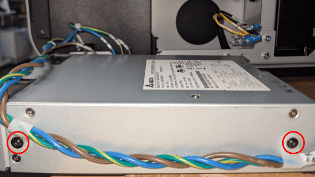 Remove the power supply assembly cable harness screws