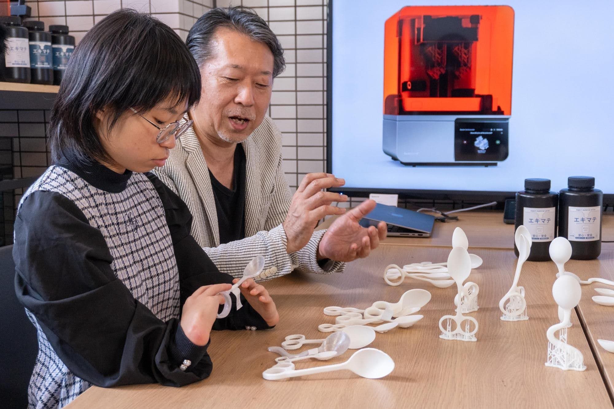 people looking at 3d prints