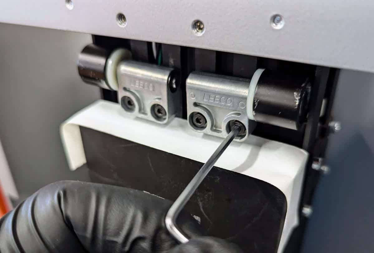 Removing the Form 4 cover hinge screws from the Z-tower