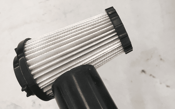 A vacuum hose is being brought to the intake filter