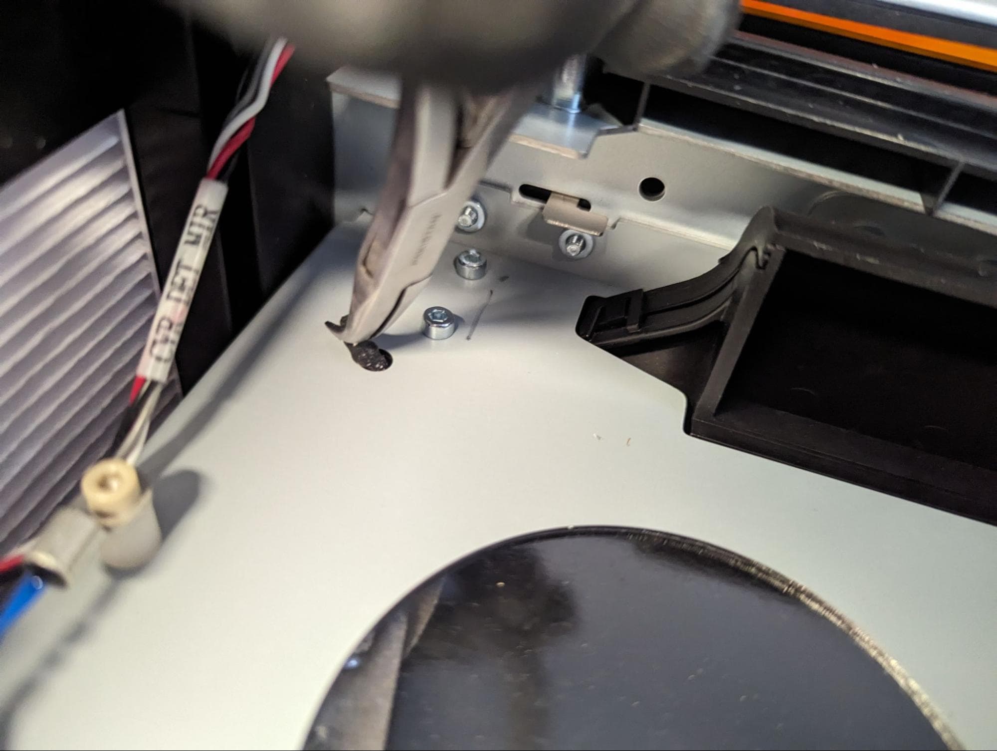 Pulling the Form 4 upper LPU fan mounting pin fully into position