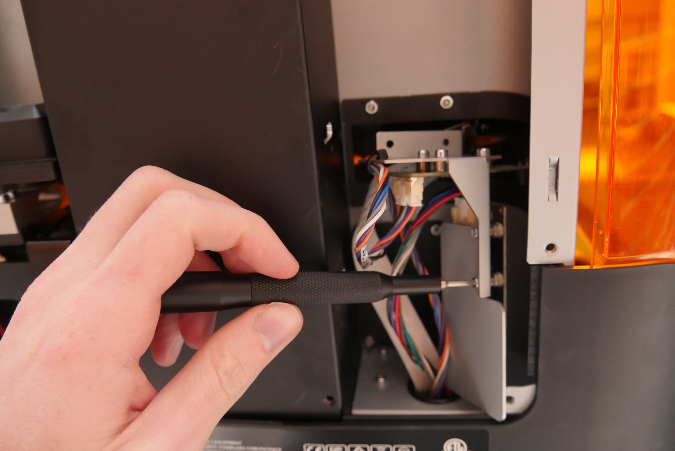 Remove the resin tank RFID board mounting screws