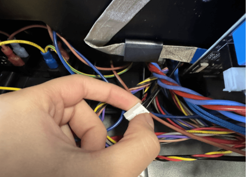 Gently pull the motor cable by the plastic housing through the slot.