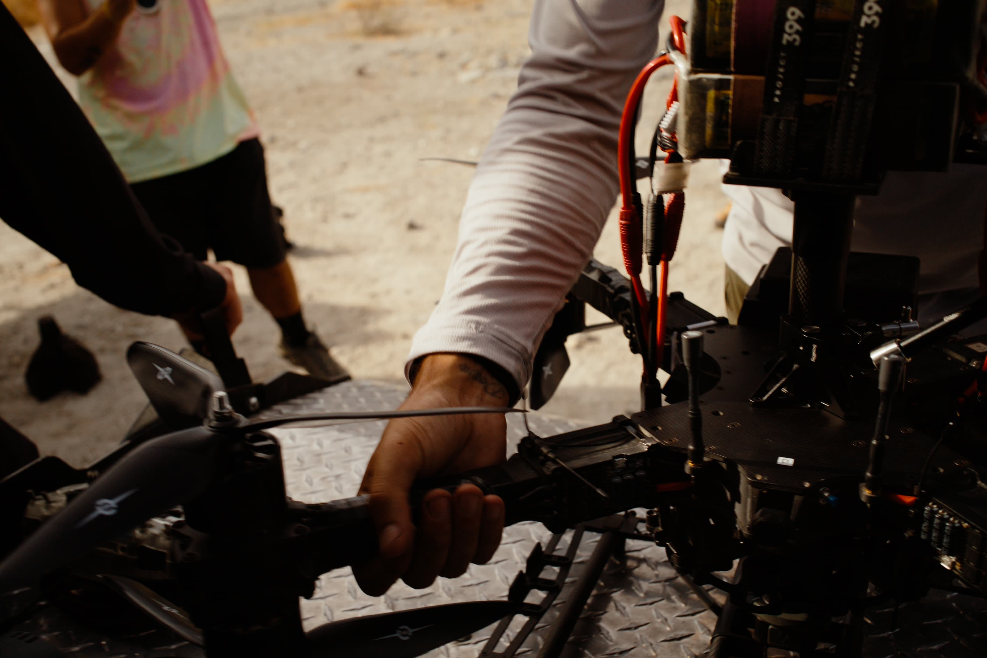 Engineer holding a black, 3D-printed drone arm