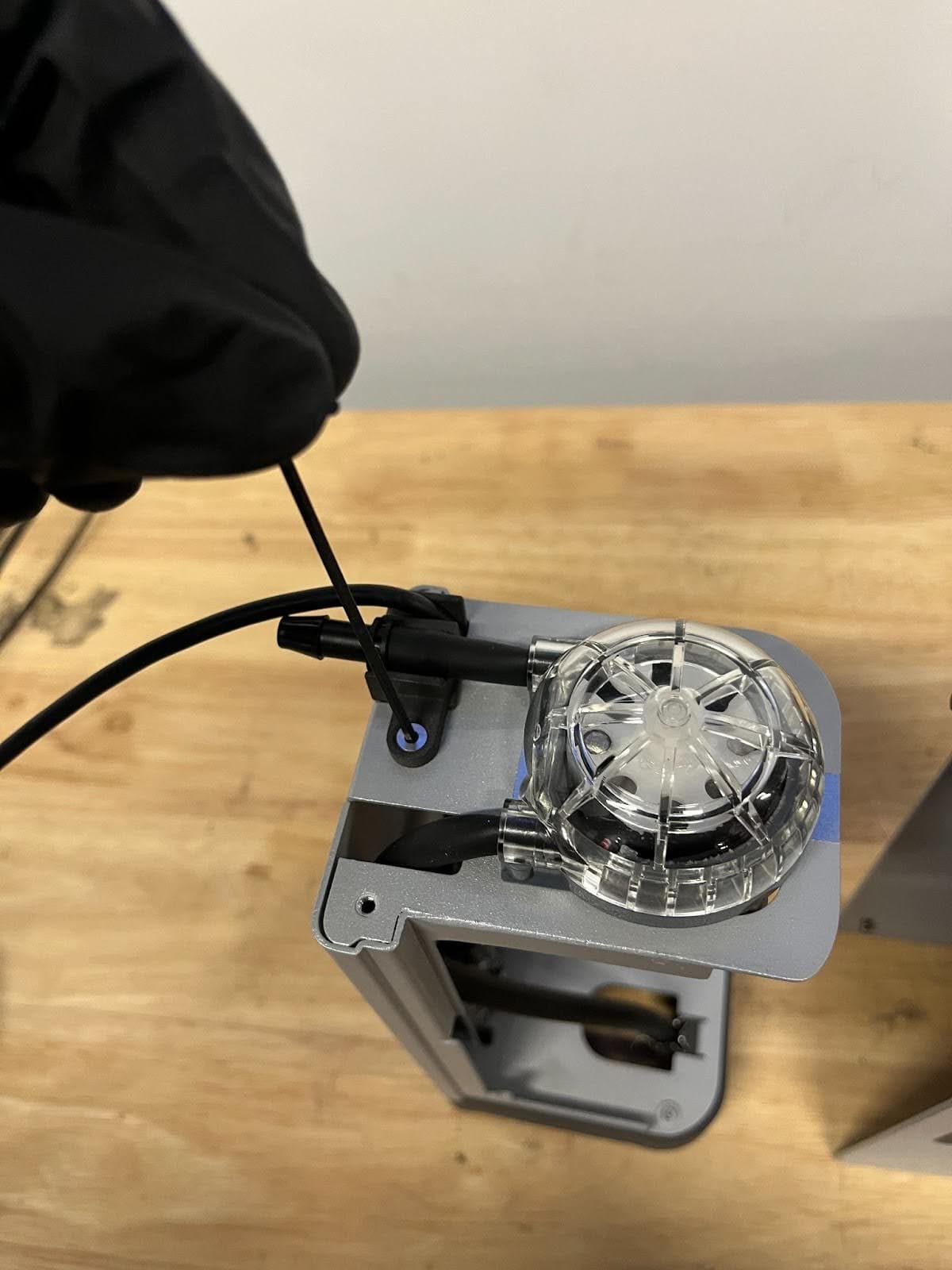 Using a flathead screw driver, remove the strain relief insert screw.