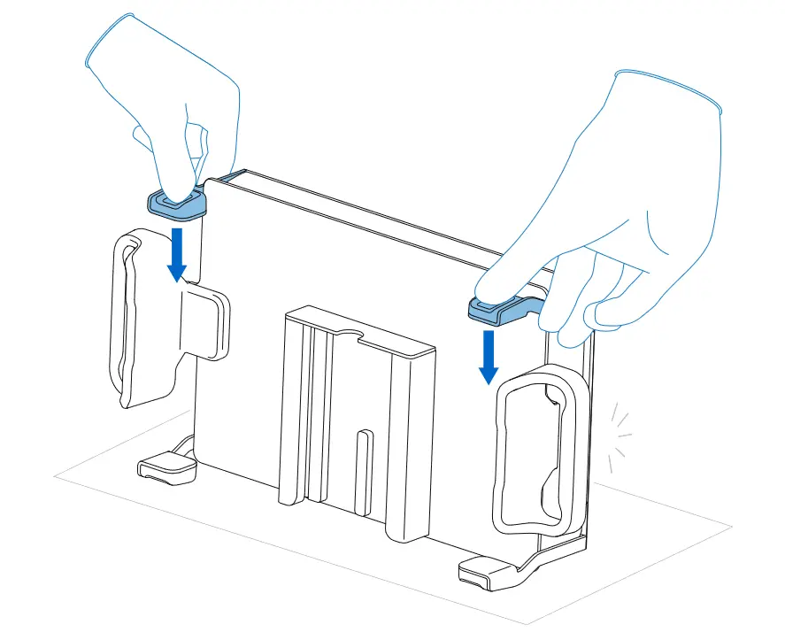 The Build Platform 2L is placed on its side with the printed parts facing away. Two hands push both part release tabs downwards to release the small part.
