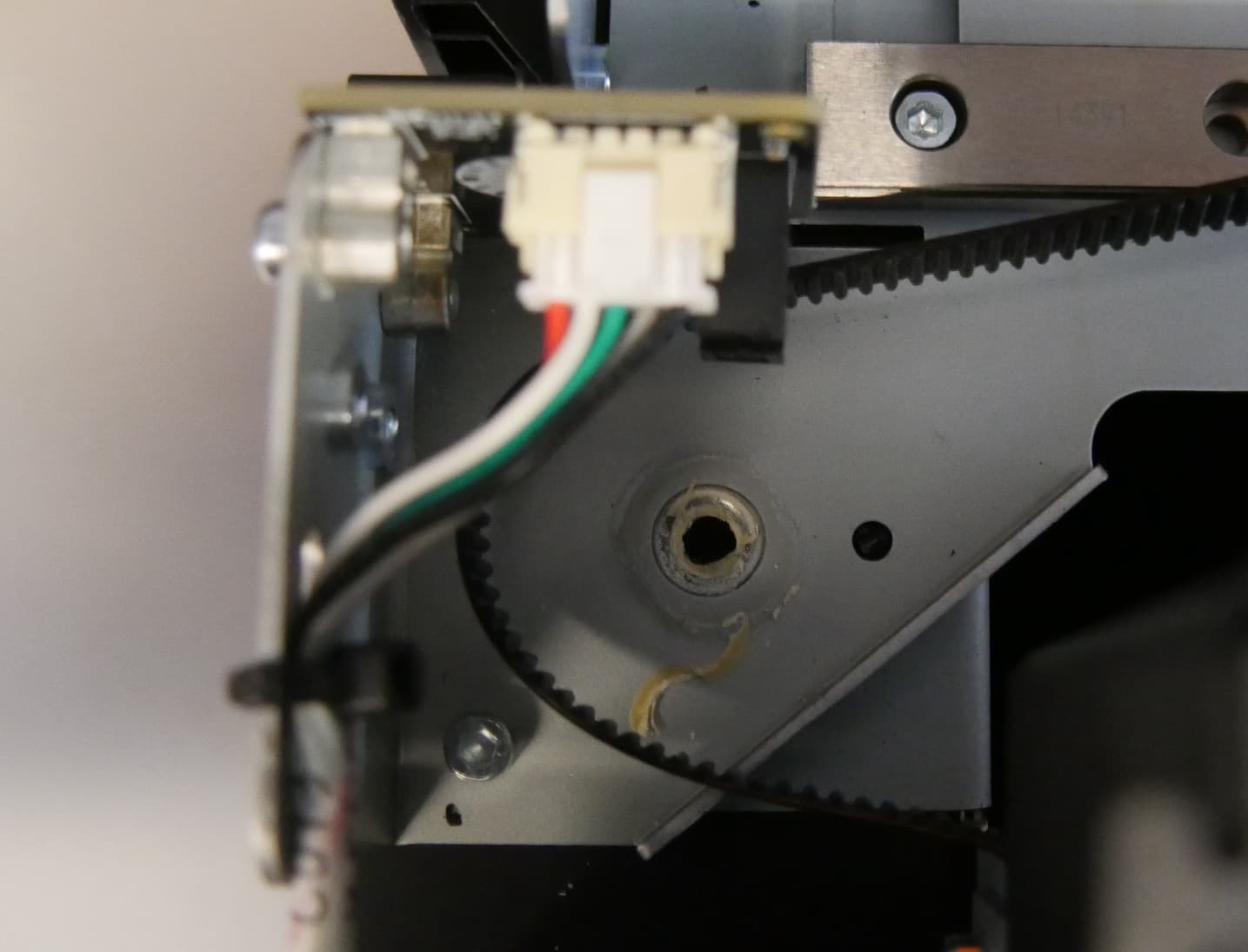 Step 2: Remove the mixer idler pulley and encoder wheel assembly