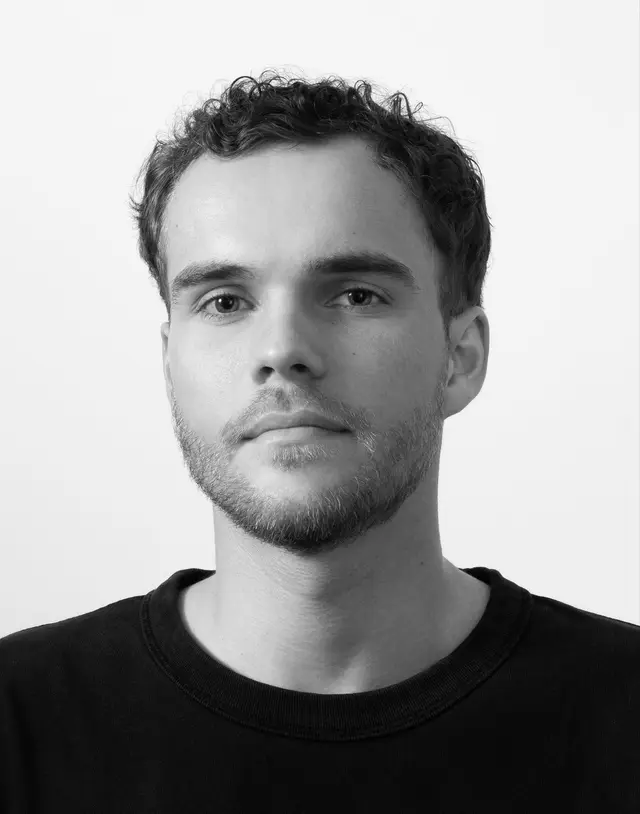 A black and white photo of Ken Pillonel, founder of YouTube Channel exploring the simulation