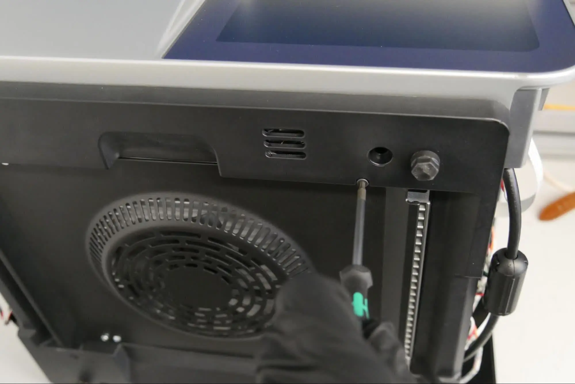 Step 7: Loosen the bottom panel retention screws