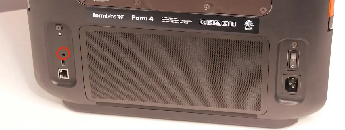 The factory reset button on a Form 4 generation printer