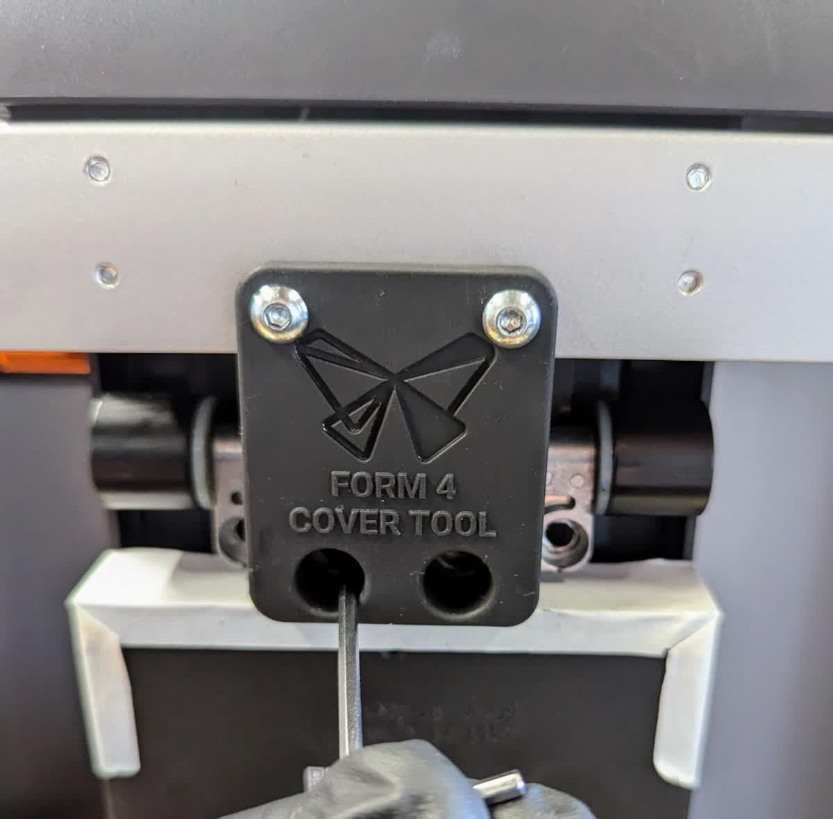 Loosely installing the Form 4 cover hinge screws with the cover tool