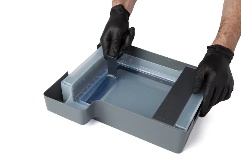 A photo showing the tank tool being held against the right side of the tank opposite the mixer.