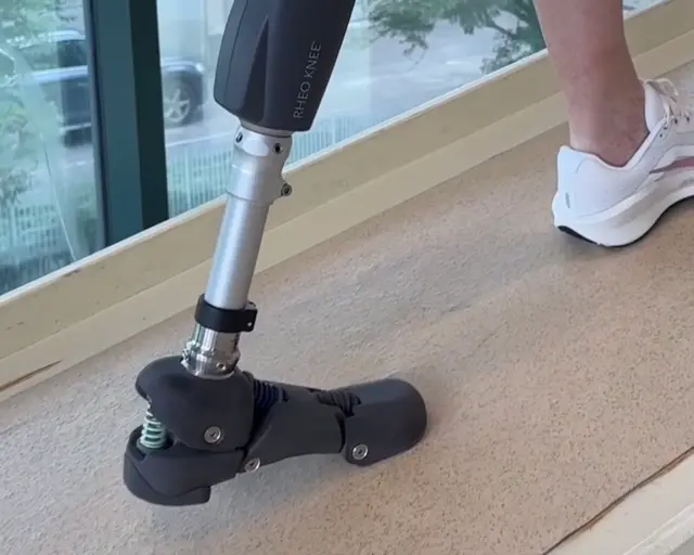 Person using a NOVA Foot prosthetic walking up a ramp