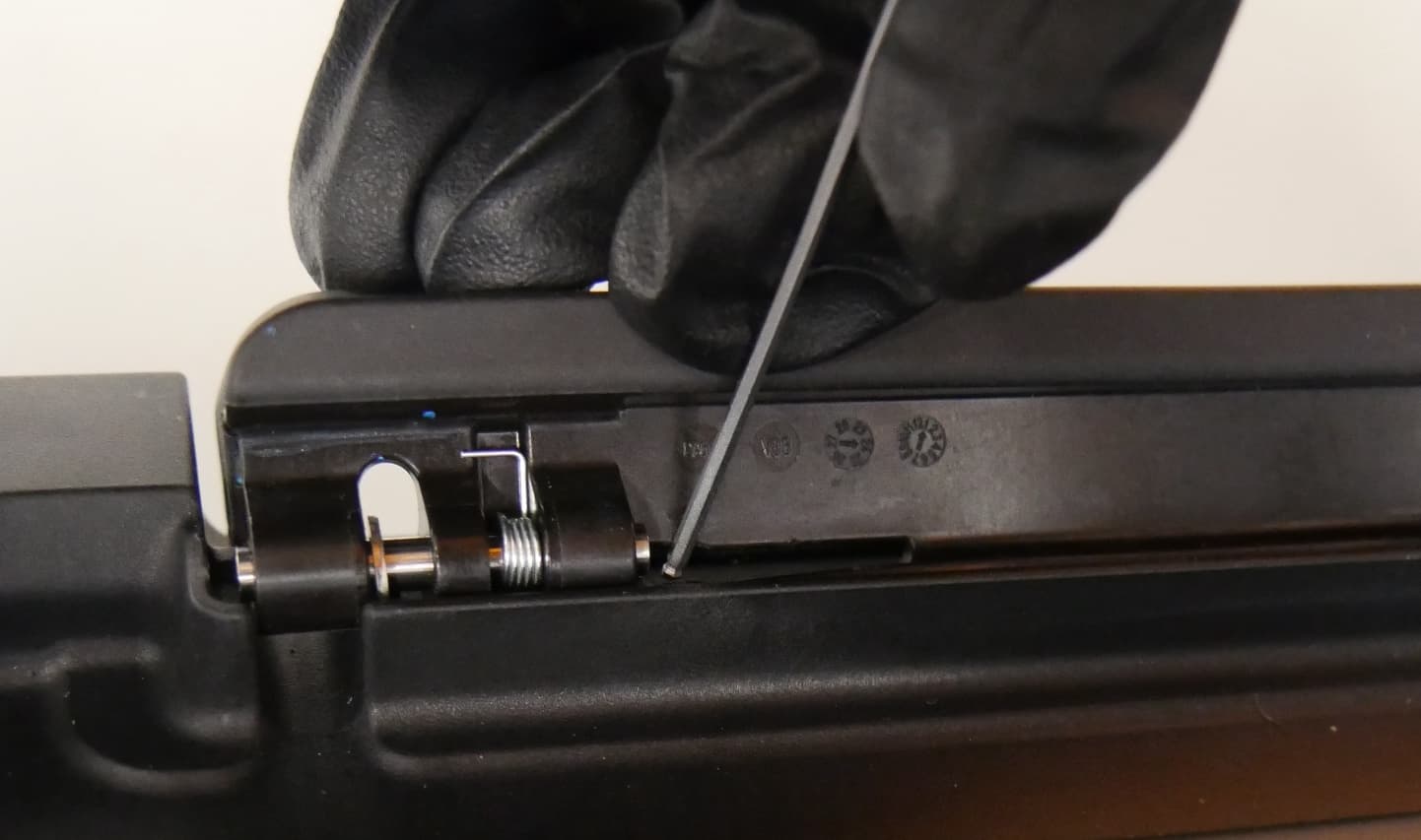 Lift the resin tank latch and locate the black retaining tab behind each pin.