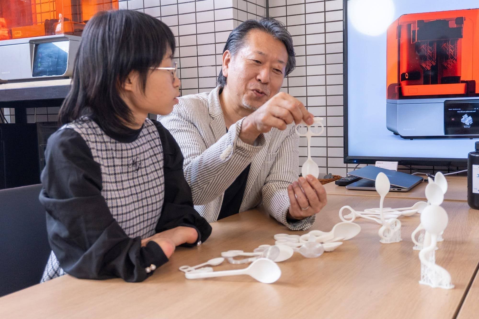 people looking at 3d prints