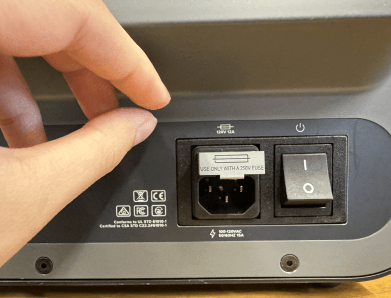 Press the fuse back into the machine in the correct orientation until it lays flush with the machine.