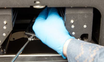 The hand mirror is blocked as the swab is fully inserted through the print enclosure