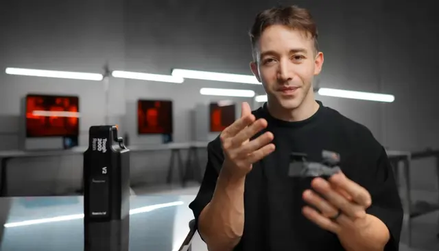 Ali Sayed holding a Zeromouse in front of Form 4L 3D printers