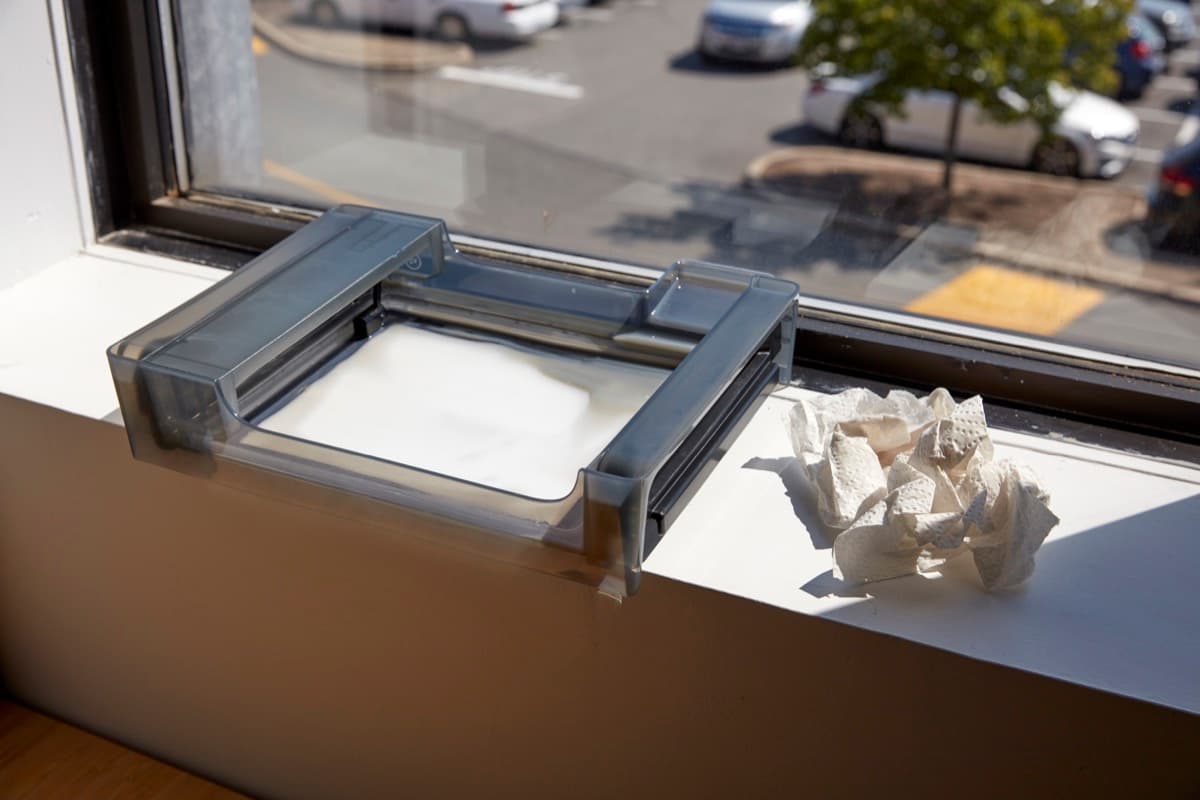 Form 3 resin tank left on a window sill to cure excess resin.