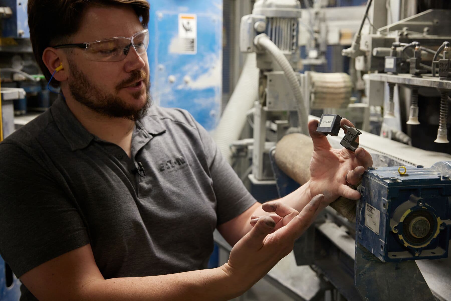 a man shows two manufacturing aids