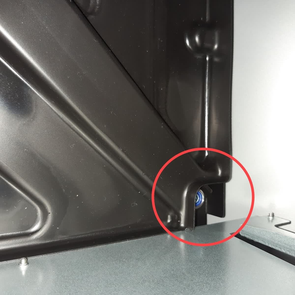 Front-right leveling foot access hole in the Form 3L drip tray