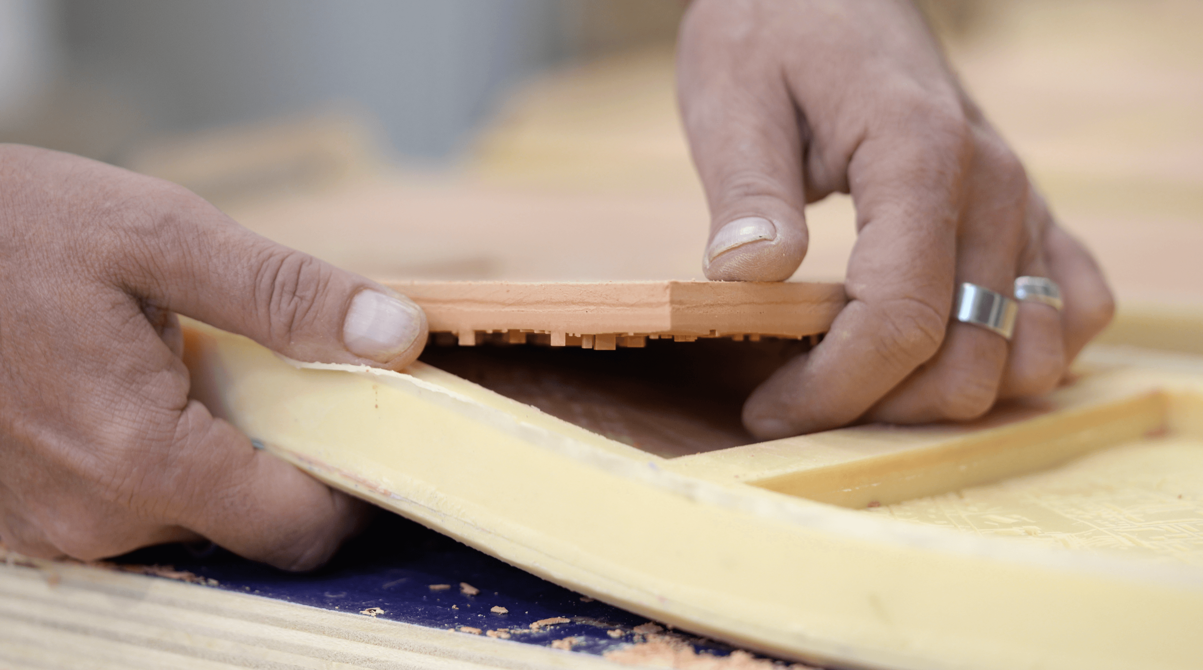 Person removing tile from mold.
